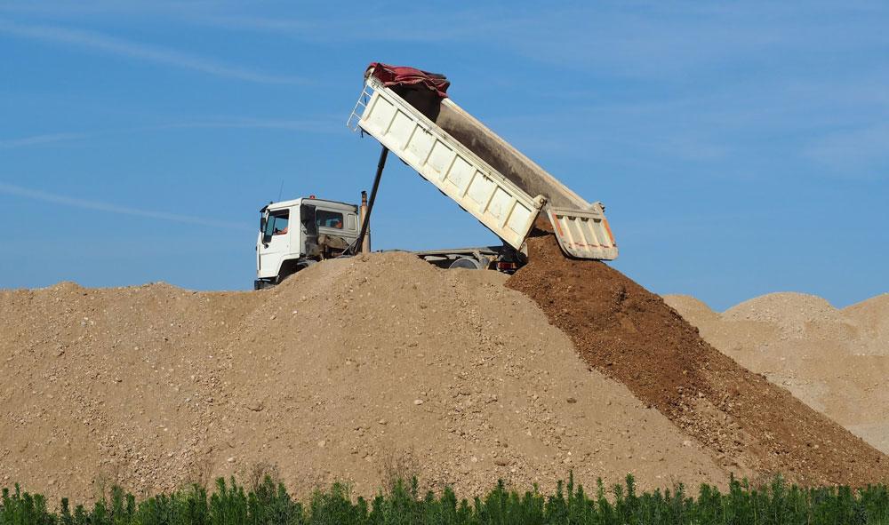 Dump truck depositing soil